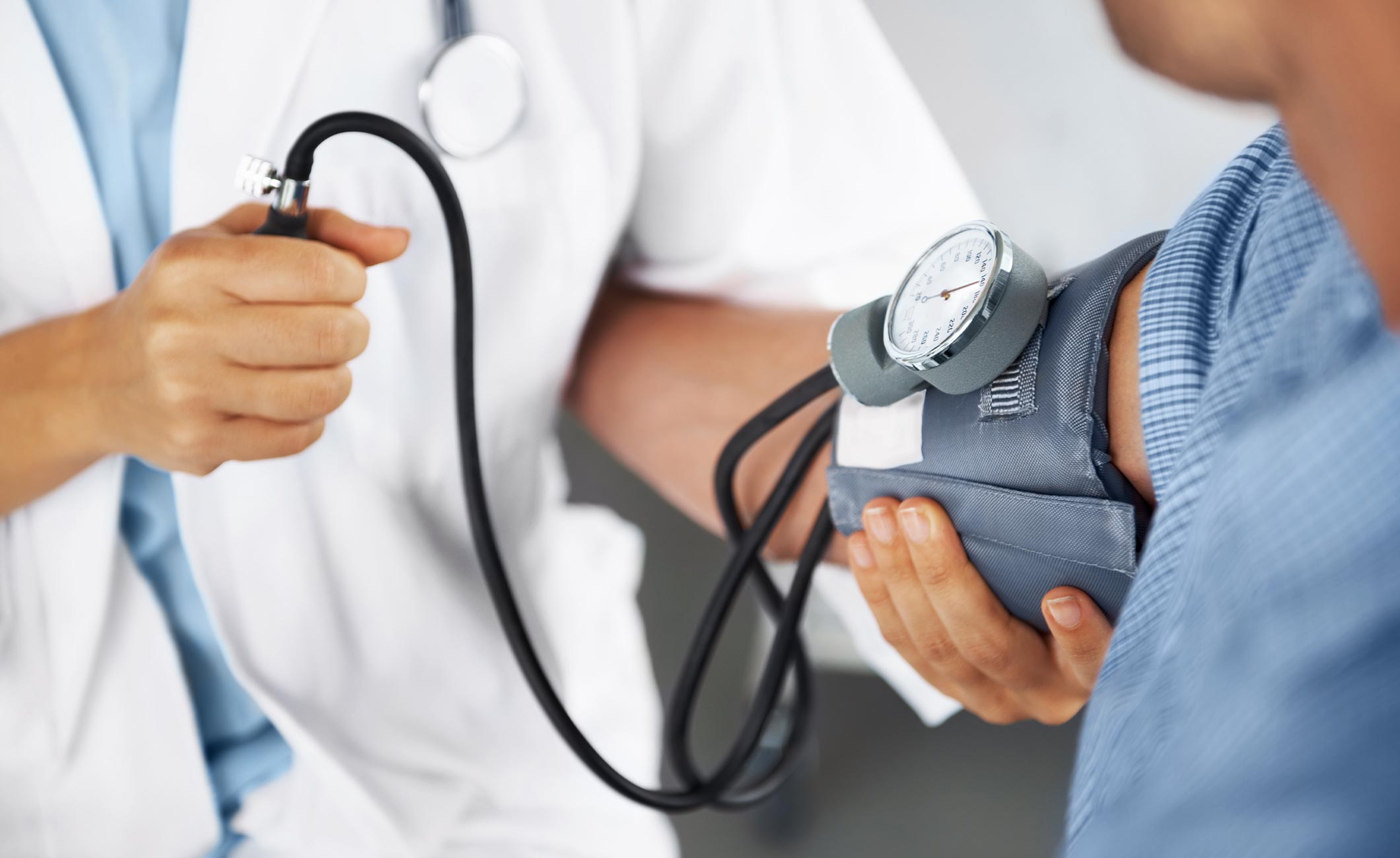 a doctor checking a patient's blood pressure 