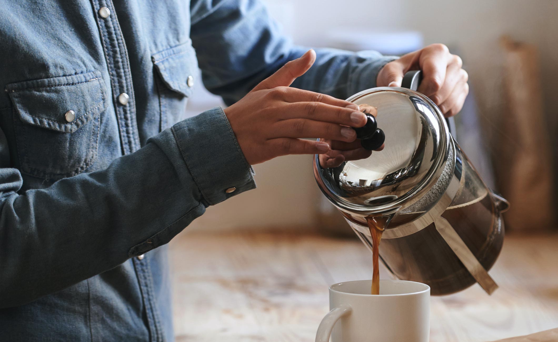 someone pouring a cup of coffee