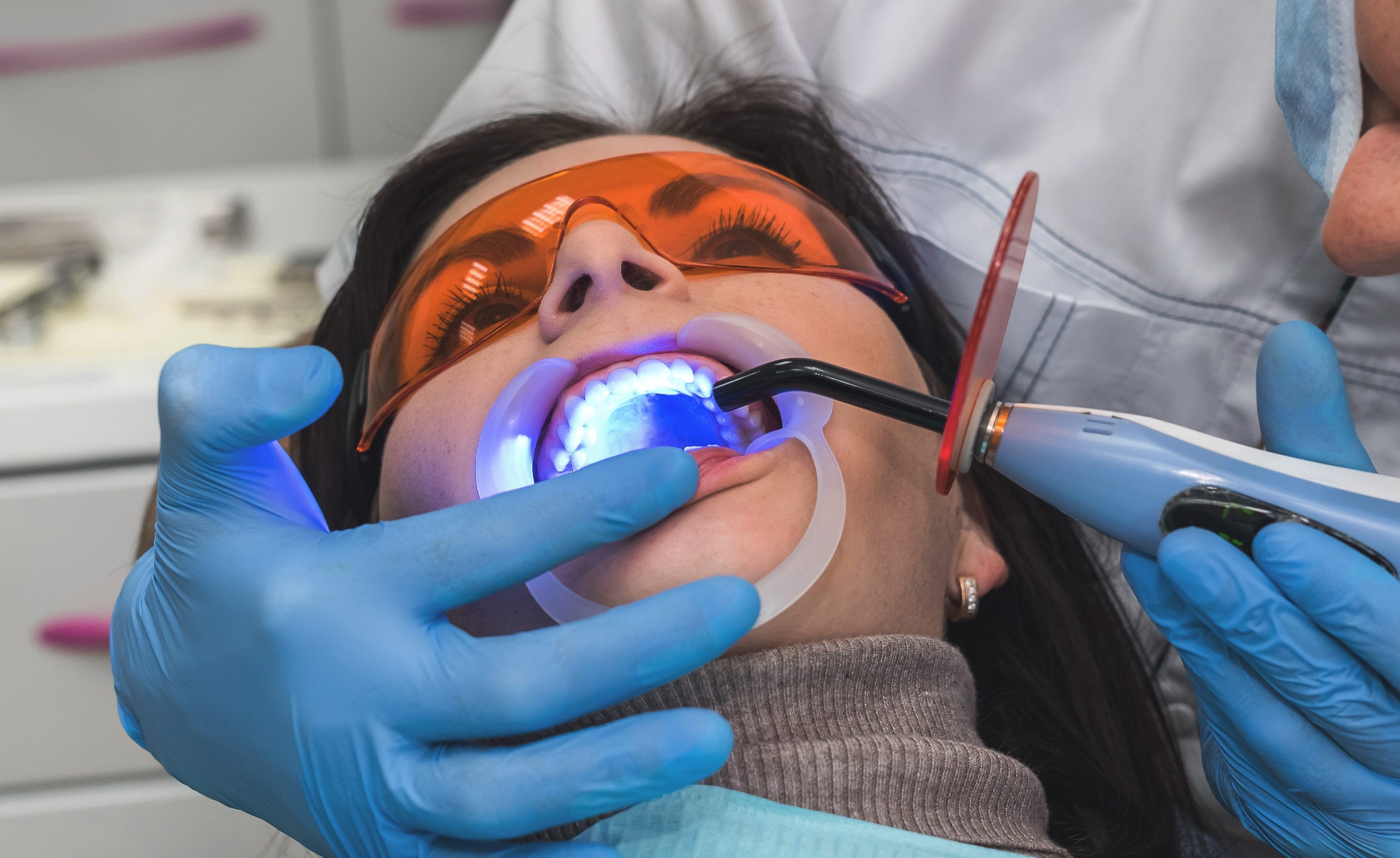 laser teeth whitening being done on a woman 