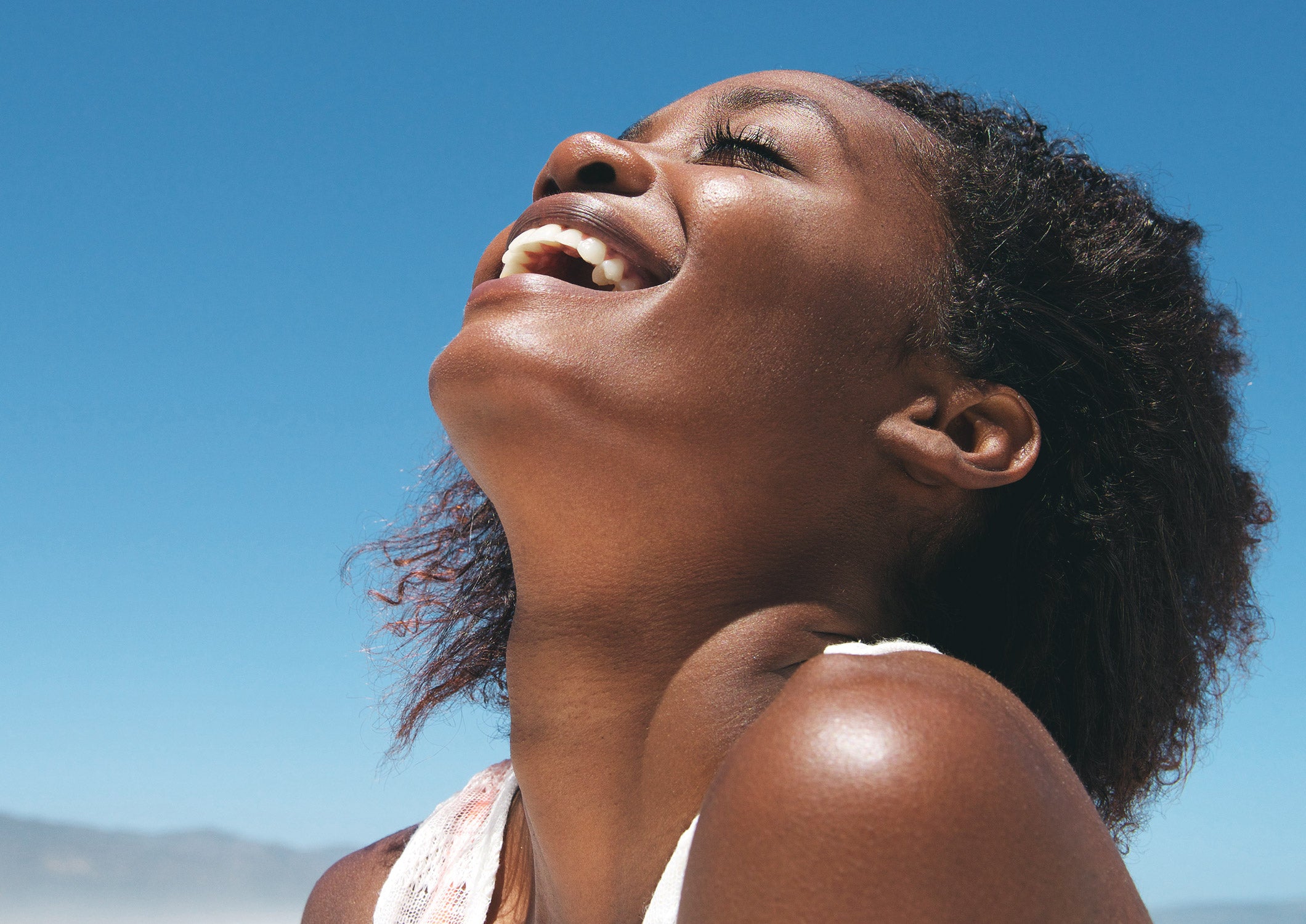 woman smiling in the sunshine 