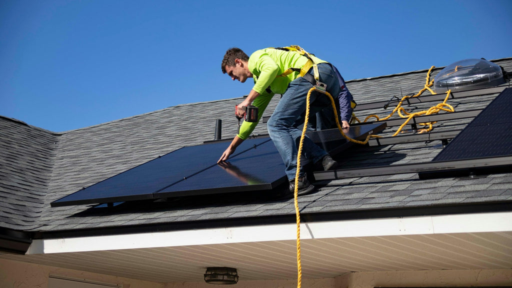Worker on a rooftop, setting up solar panels for sustainable power.