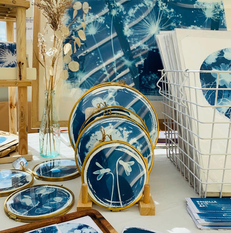 Market stall set up from Danielle East ART featuring round framed Cyanotypes and prints