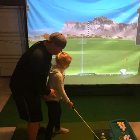 G-TRAK Retractable Impact Screen with young golfer practicing.