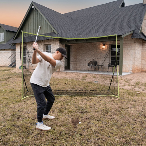 SIG 10' x 7' Rectangular Golf Hitting Net with golfer outdoors.