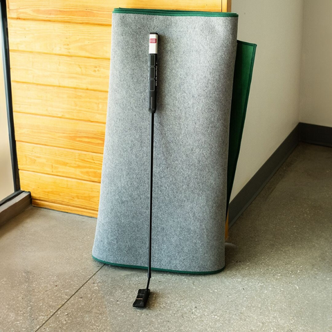 SIG LITE Indoor Putting Green 3' x 8' rolled up with putter.