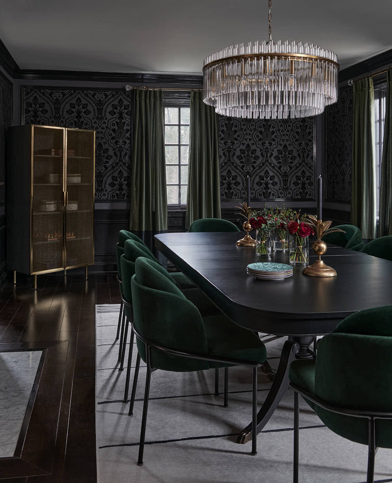 Brass and cut-glass round chandelier casting a warm glow in the dining room