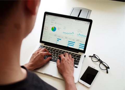 a man monitoring his marketing campaign on a laptop