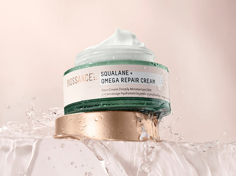 Squalane + Omega Repair Cream with cap off and water flowing