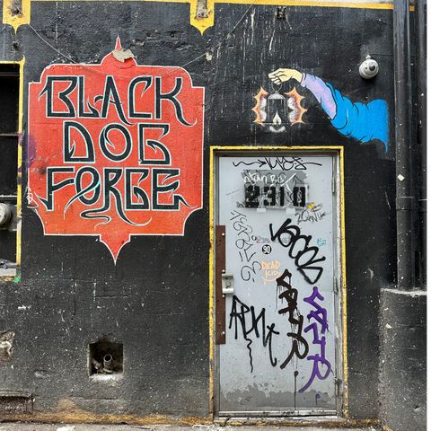 Graffiti and posters decorate the entrance to Black Dog Forge in Seattle, a significant rehearsal space for iconic bands like Temple of the Dog.