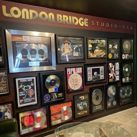 Wall of fame at London Bridge Studio showcasing gold and platinum records by Pearl Jam, Alice In Chains, and more.