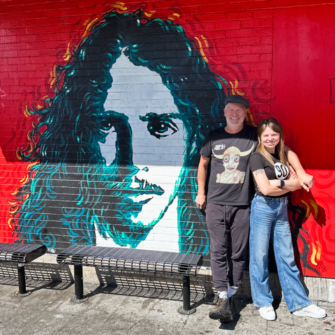 Matt Vaughan, owner of Easy Street Records, and Anita Stelmasiuk from 90 Clothing, posing in front of a Chris Cornell mural.