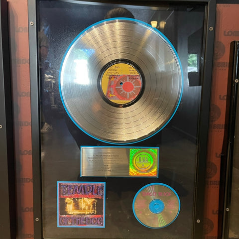 Close-up of Temple of the Dog's platinum record displayed at London Bridge Studio, celebrating over a million sales.