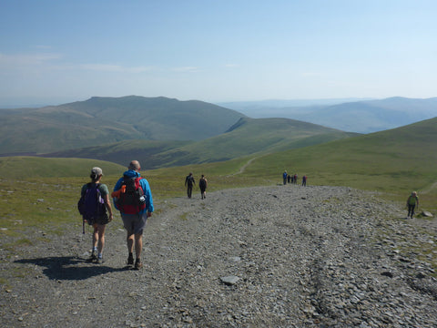 hikers on track in Lake District hills during mental health walk