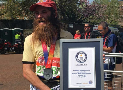 Forrest Gump lookalike runner Rob Pope - man with cap, long hair and beard displays running certificate