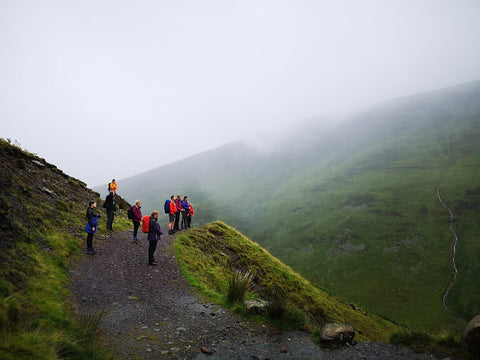 group of people on path in lake district practising mindfulness with mind over mountains mental fitness charity