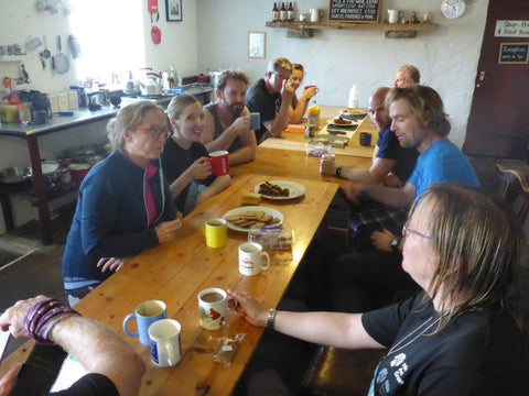 group of hikers eating at table at hostel after mental wellbeing walk lake district