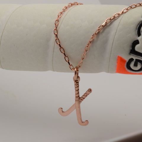 Rose gold crossed hockey stick necklace