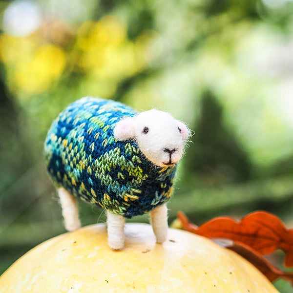 Bertie felted sheep by Mary Kilvert, standing on a squash