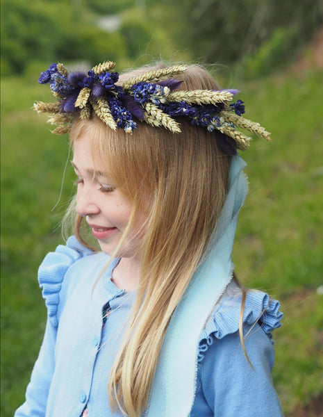 A child wearing a beautiful purple flower crown