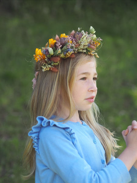 A child wearing a beautiful colourful flower crown