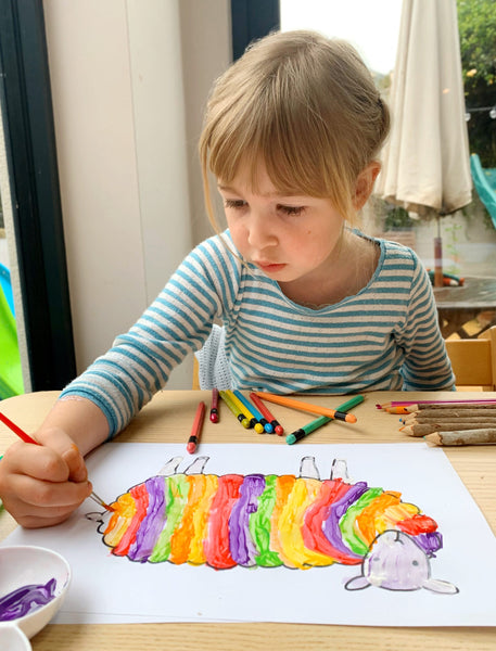 A girl painting a picture of a sheep for a Mary Kilvert Competition