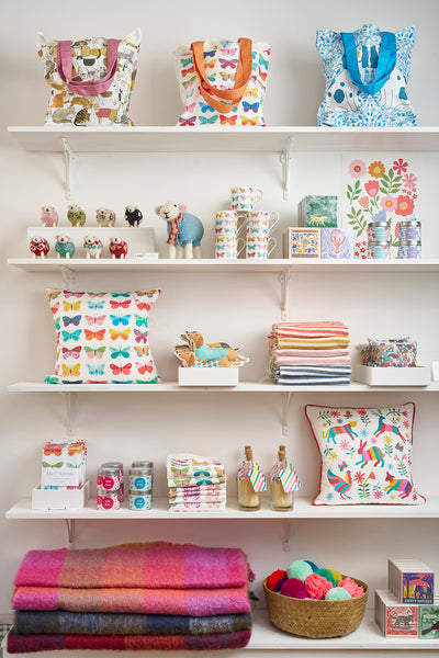 Shelves with a beautiful display of Mary Kilvert's colourful homewares in her Frome shop