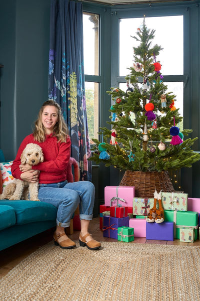 Mary Kilvert with her beloved dog Honey sitting next to a Christmas tree