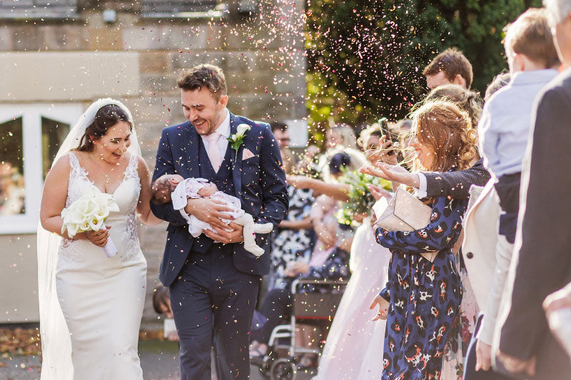 Newlyweds celebrating with petal confetti
