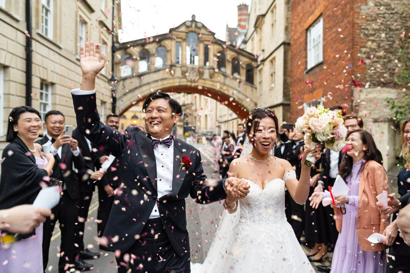 Newlyweds celebrating with petal confetti