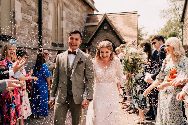 Newlyweds celebrating with petal confetti