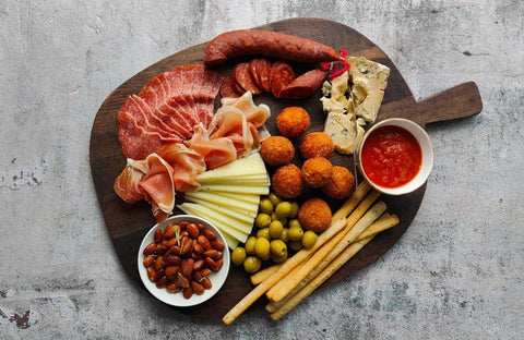 Sharing platter with cheese, charcuterie and arancini