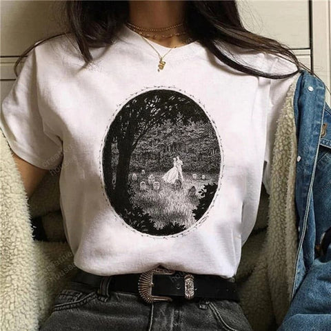 Woman with wedding printed t-shirt dancing in a forest with graves