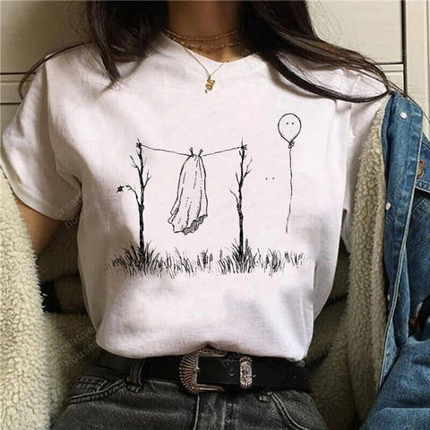 Woman showing t-shirt printed with a ghost who is waiting for the bag she puts on to see herself to dry