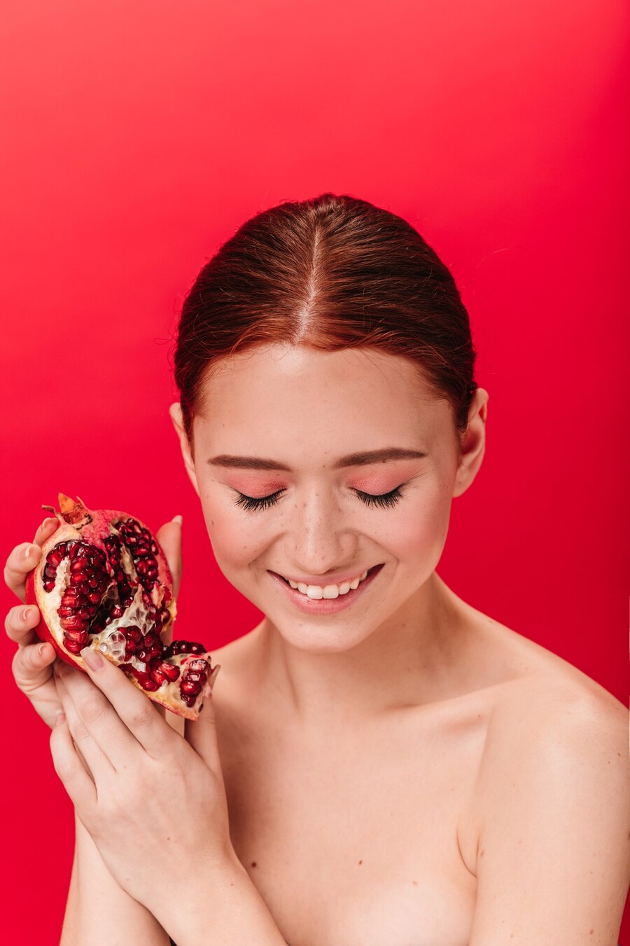 wonderful-ginger-girl-with-garnet-laughing-with-closed-eyes-studio-shot-blissful-young-woman-posing-with-ripe-pomegranate_197531-17758