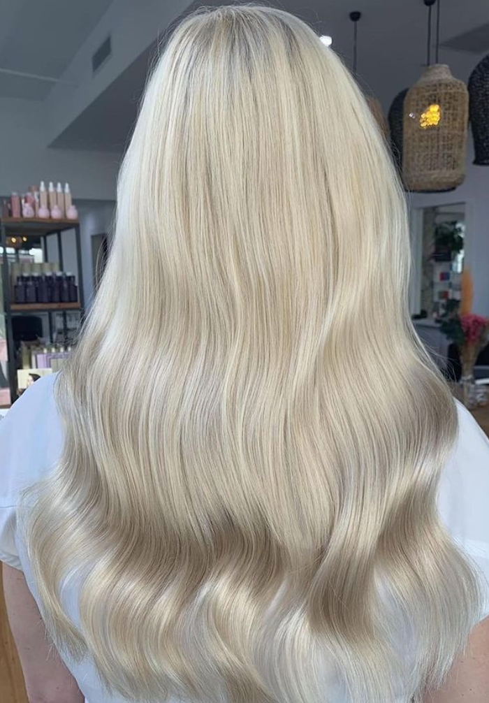 woman donning The Medium Halo in Col. #20C Cream Blonde halo hair extensions