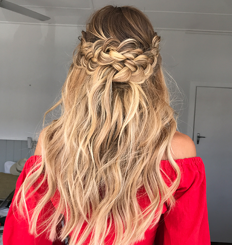 blonde woman with a half up braided bridesmaid hairstyle