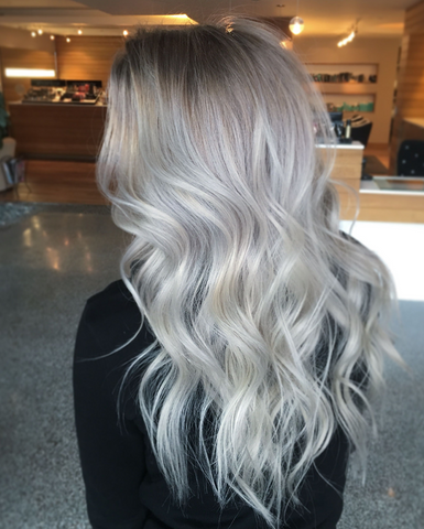 silver blonde hair curled and shown from behind to represent the different types of blonde hair available to clients