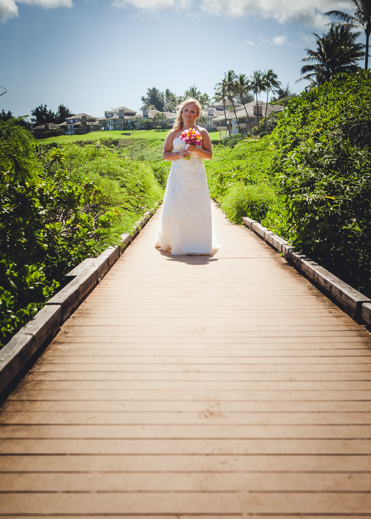 Brides walks along walkway in Maui, Hawaii