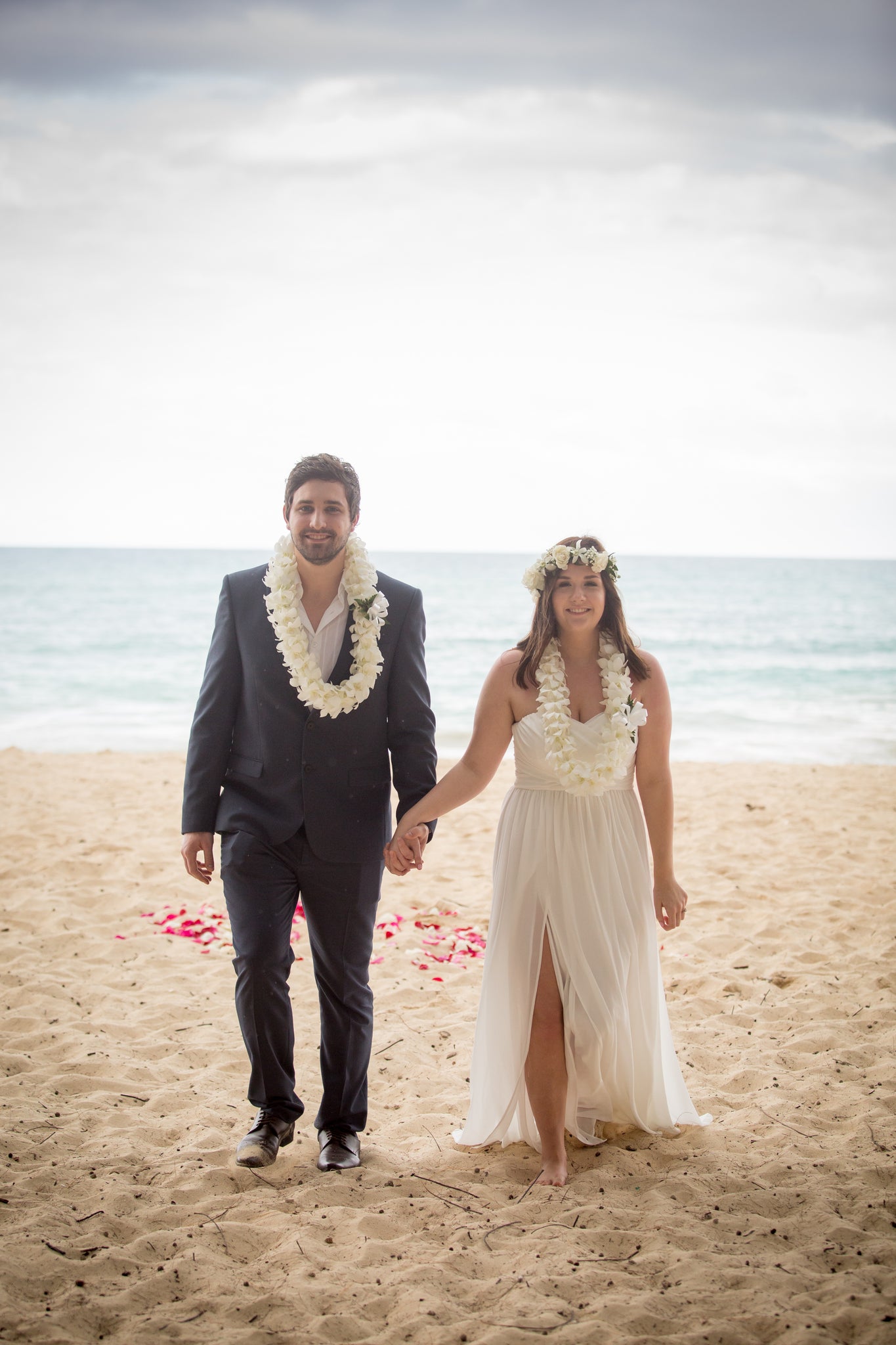 New Husband and Wife walk along the beach