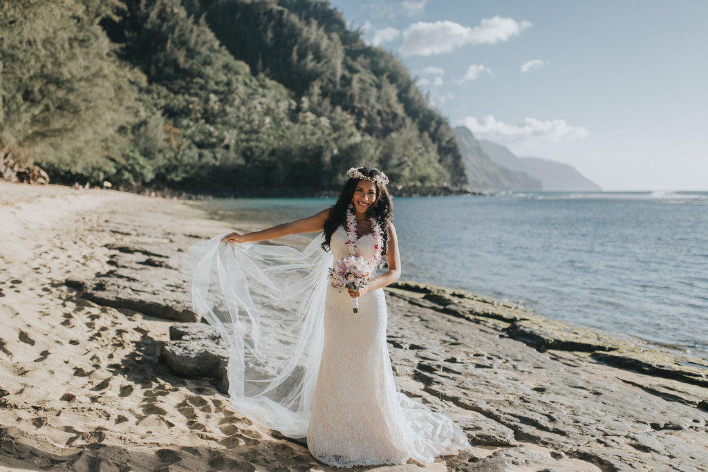 Bride poses with her dress in Kauai