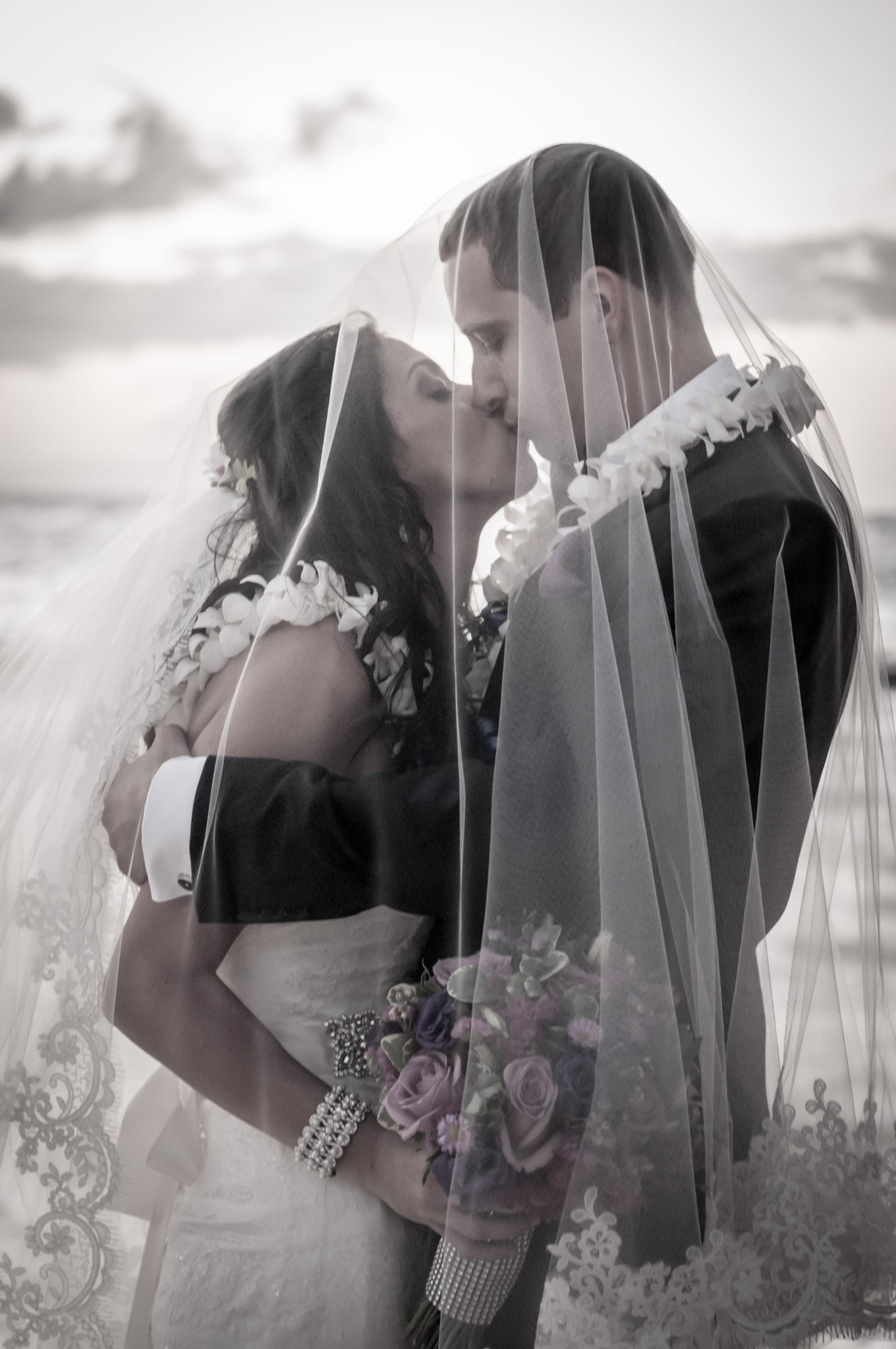 Bride and Groom kiss under the veil