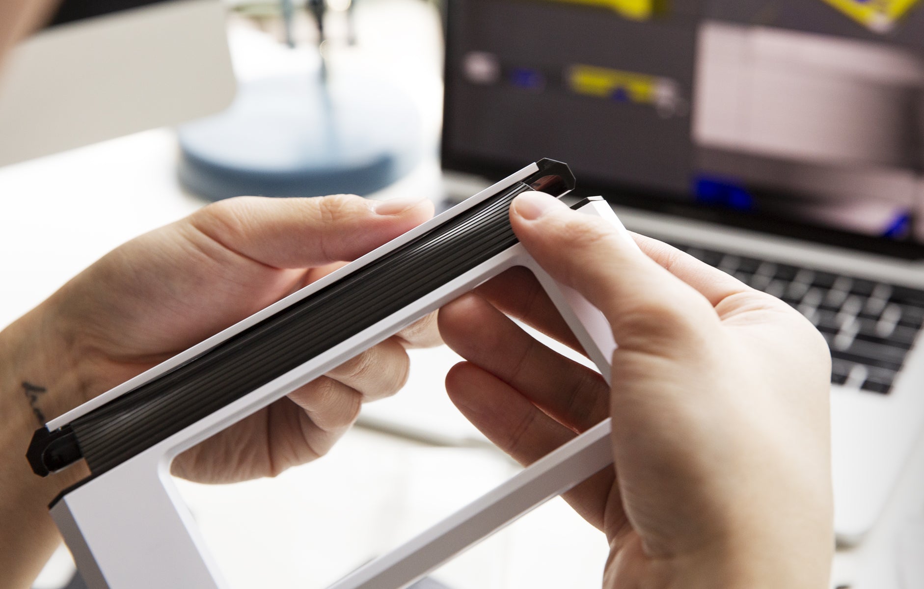 Hands holding on to a Galaxy Fold white case