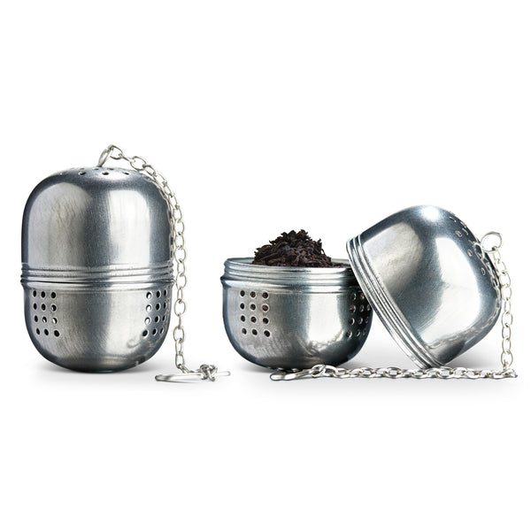 Classic stainless steel teaballs, one closed one open with black tea inside