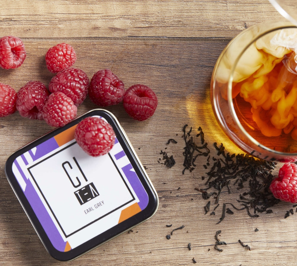 earl grey tea with milk and raspberries on a table