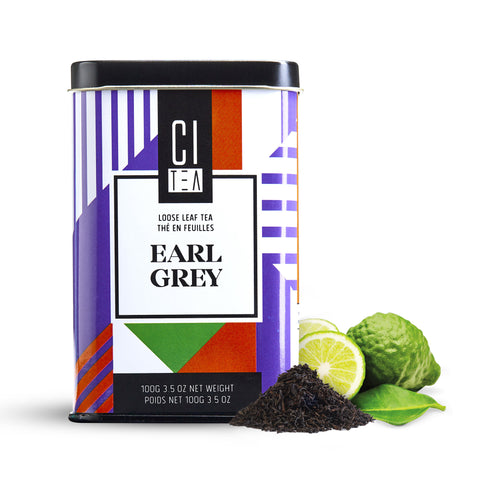 Boîte à thé Earl Grey avec thé en feuilles et bergamote à côté