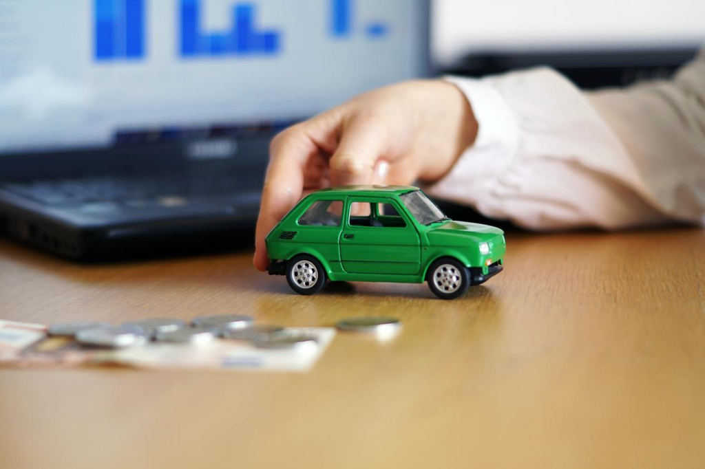 A toy car and coins were strewn across a trolley tax-computing expert's desk