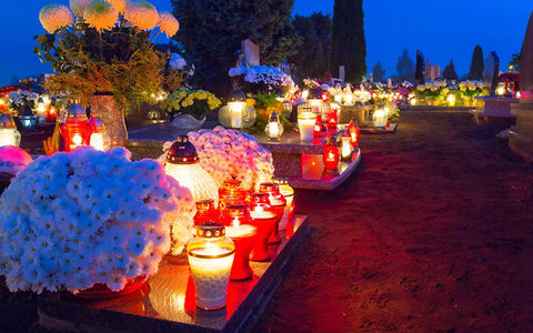 All Saints’ Day being celebrated in a cemetery with flowers and cancels around it