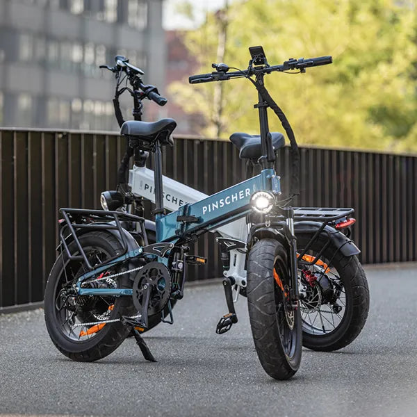 Two electric foldable fatbikes next to each other, one white and one blue