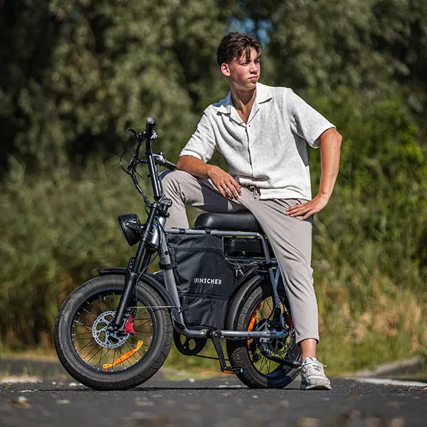 Young man lounging outside on an electric fatbike