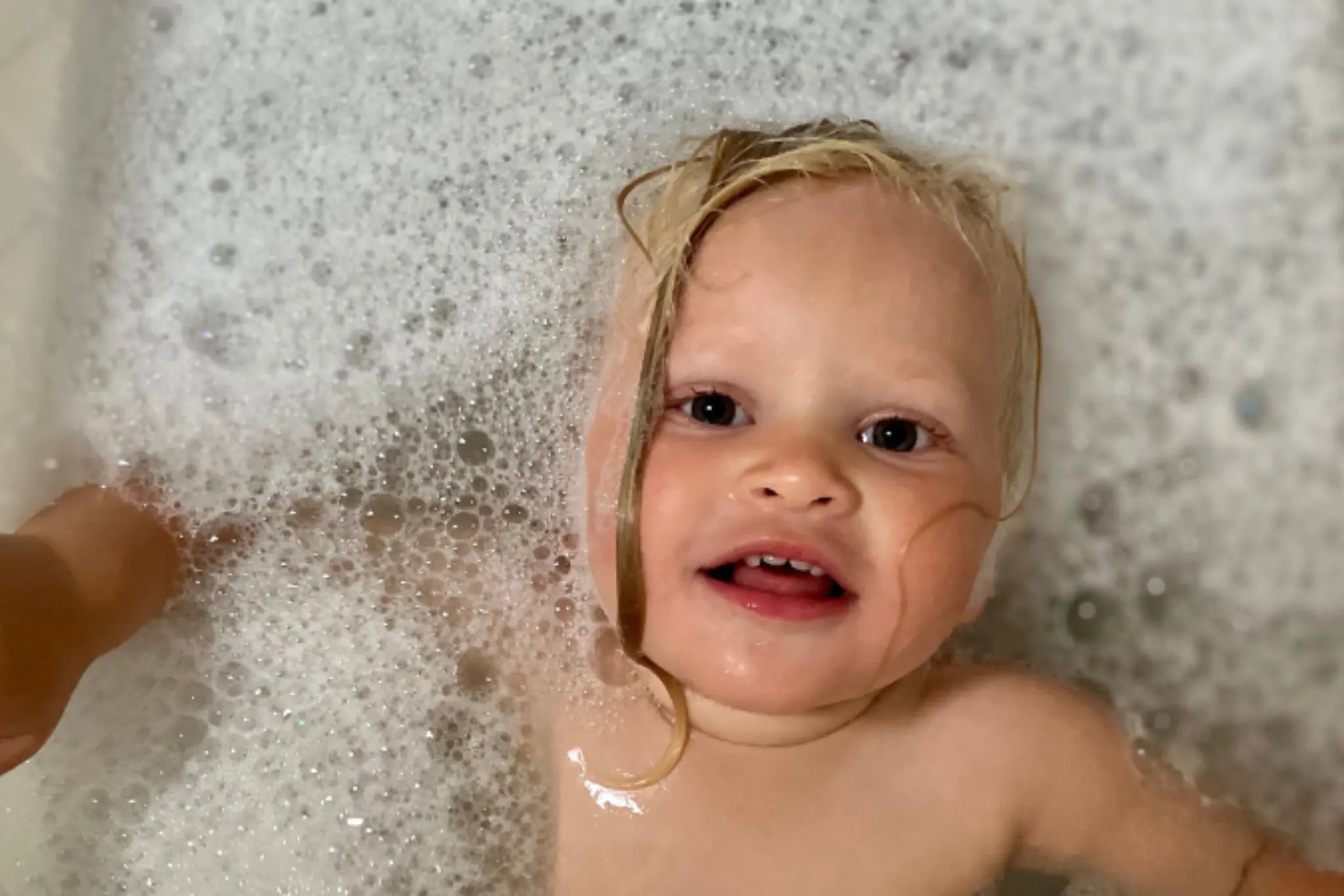 Baby taking a bath in bubbles